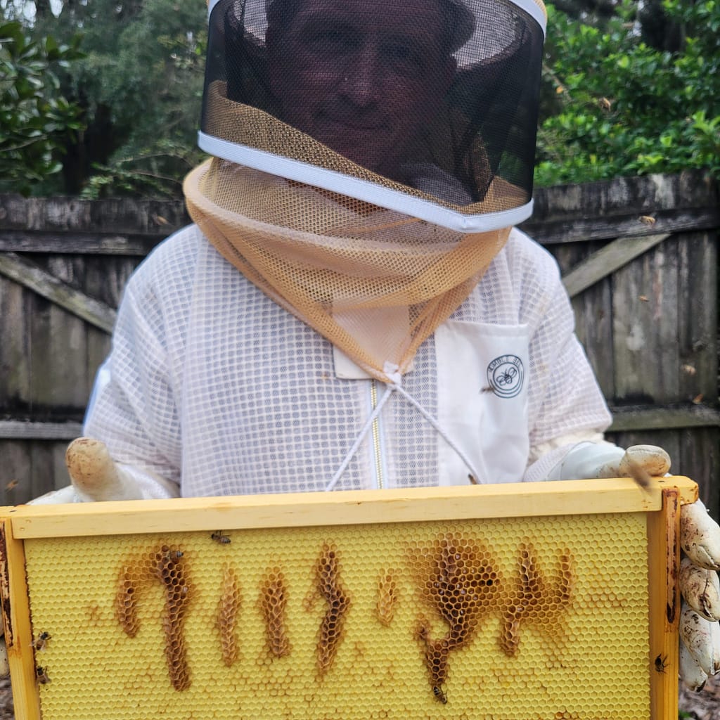 Man (Joey) Holding Beehive Frame with Strange "Symbols"