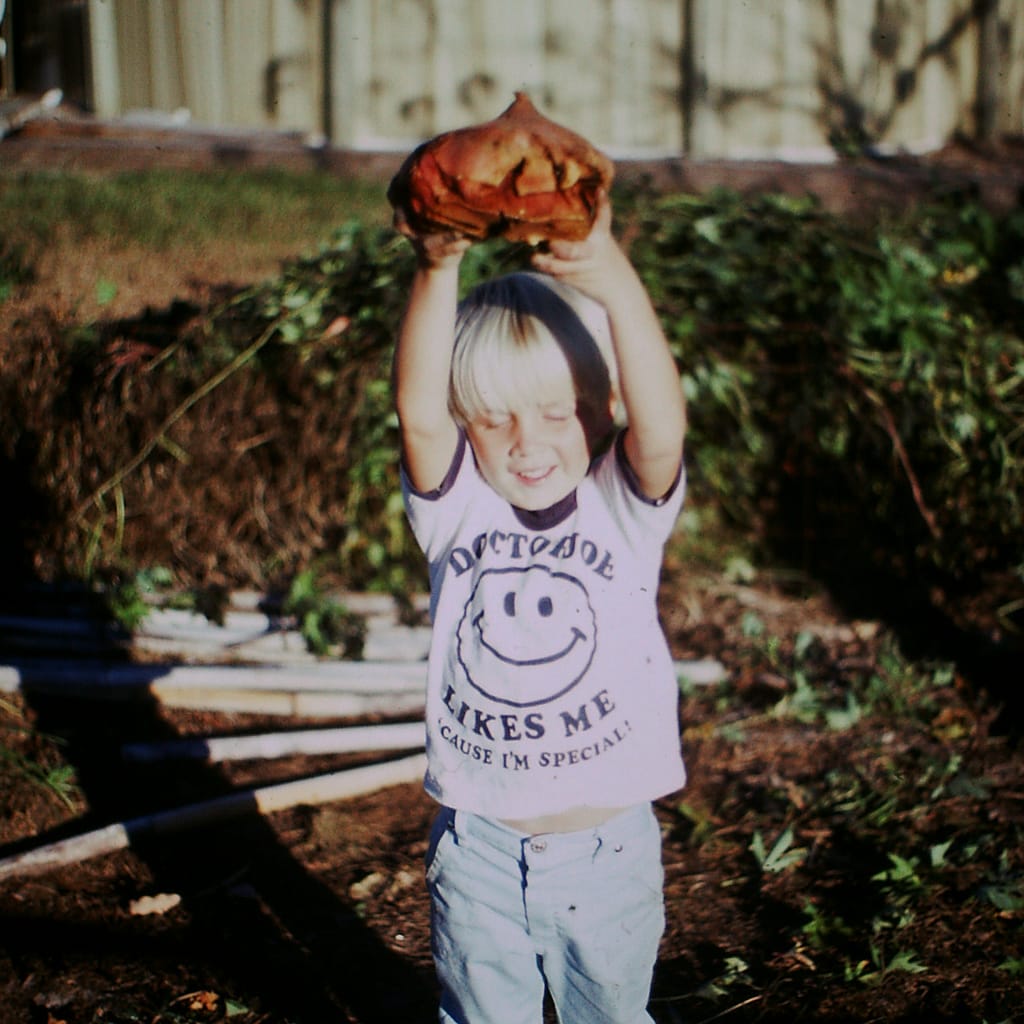 Joey as a Little Boy in the Garden with a Sweet Potato