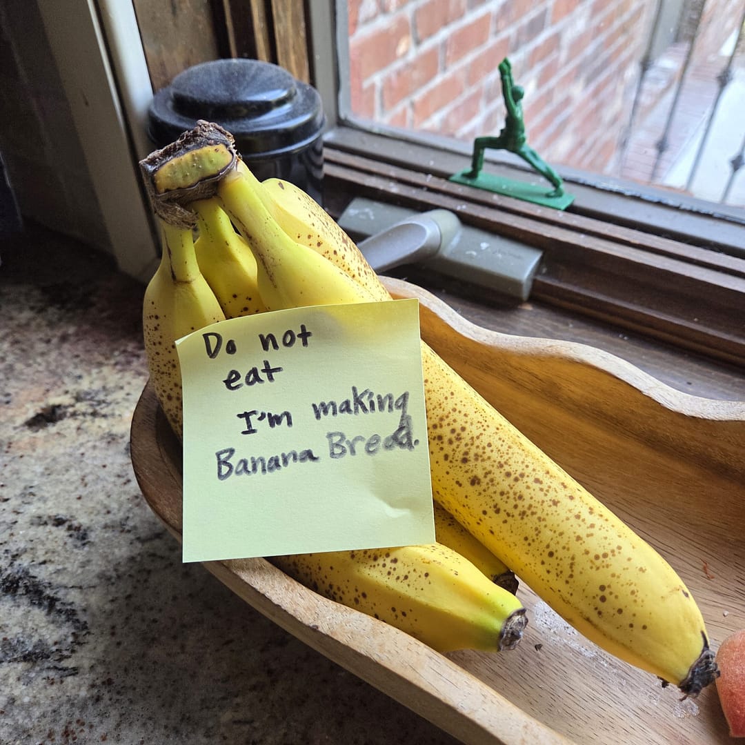 Bananas on a Counter with a Post-it Note Saying "Do Not Eat, I'm Making Banana Bread"
