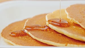 Pancakes with Syrup Being Poured on Them