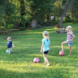 Kids Playing Soccer in the Backyard