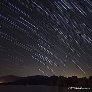 Perseid Meteor Shower in Night Sky Over Mountains