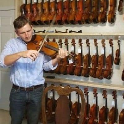 Man (Joey) Playing a Violin at a Violin Store (Many Violins on the Wall)