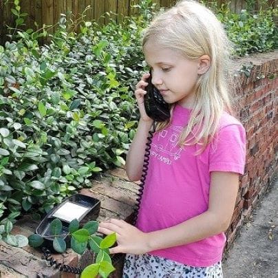 Girl on Old Phone in Garden