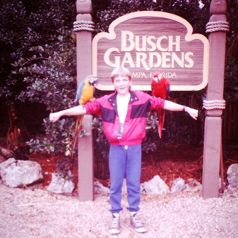 Boy (Joey) at Busch Gardens in the 80s with a Macaw on Each Arm