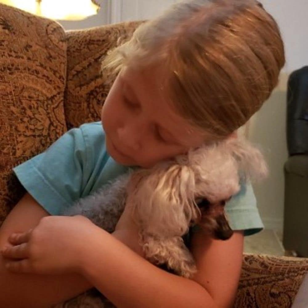 Girl (Maddy) Cuddling BooBoo the Poodle