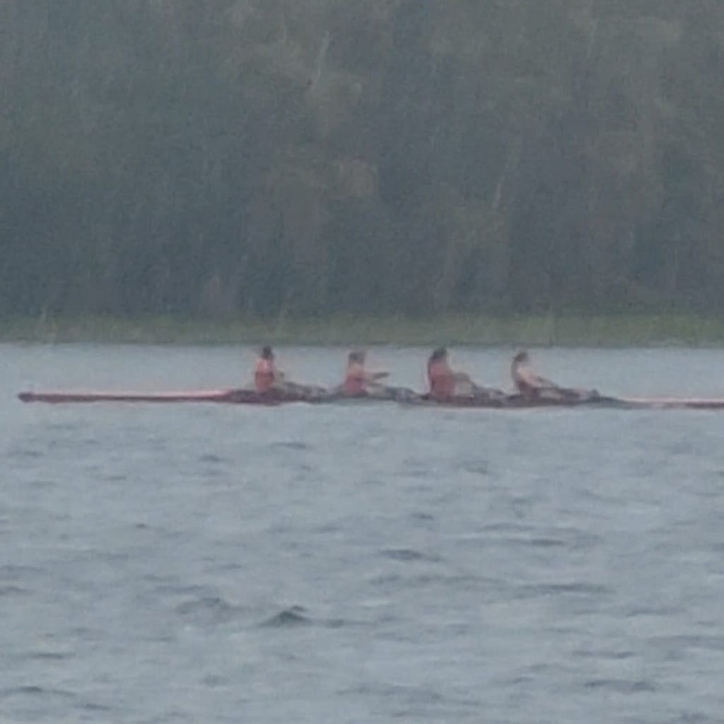 Girls Rowing Crew on the Water in the Rain