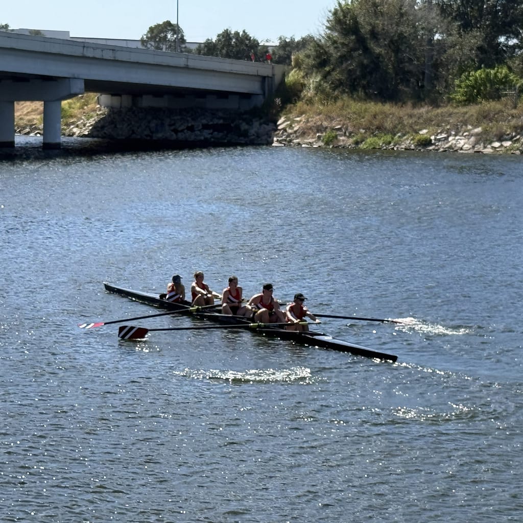 Rowing Crew of Girls on the Water in a Regatta
