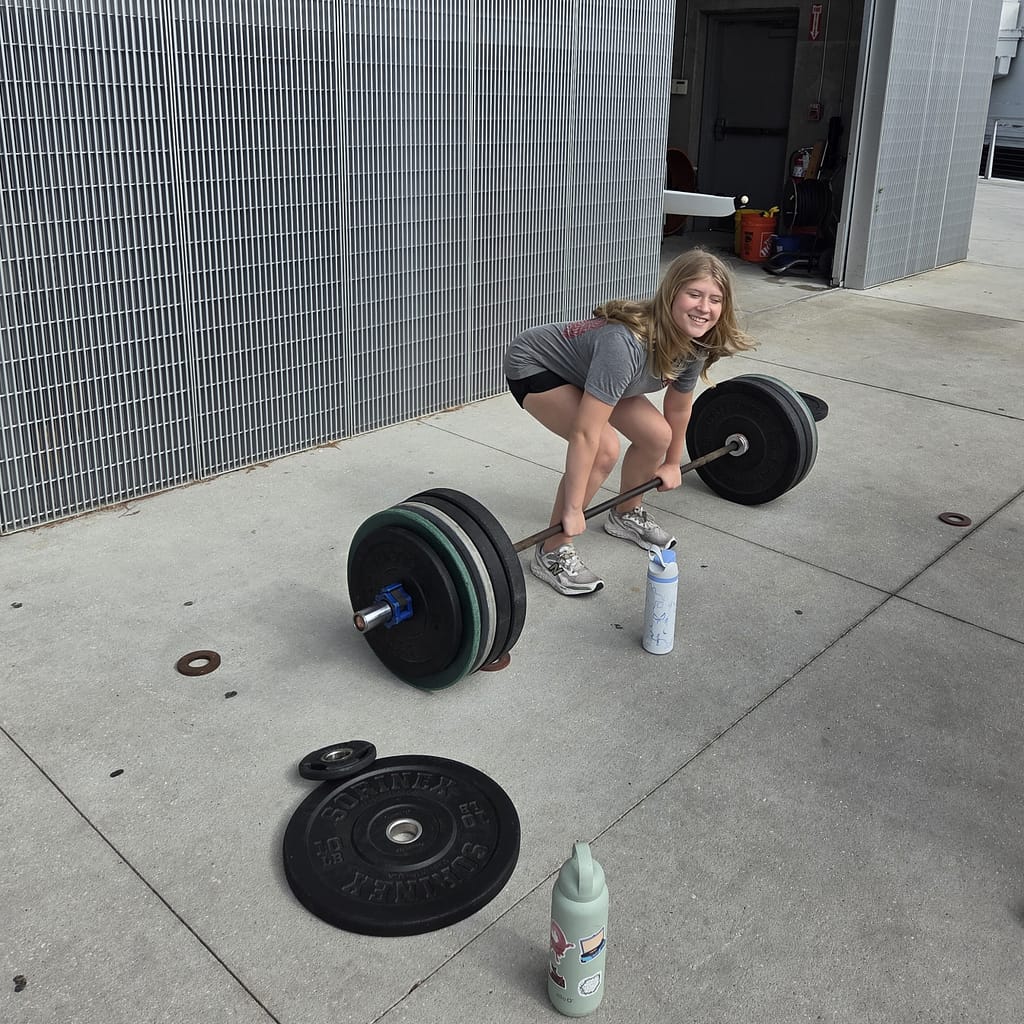 Maddy (Pre-Teen Girl) Preparing to Deadlift a Barbell