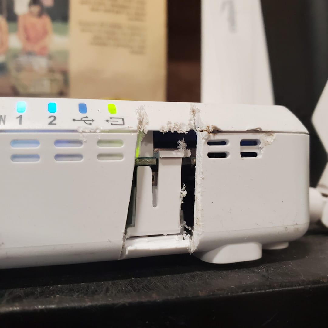 Internet Modem Cut into with a Hacksaw