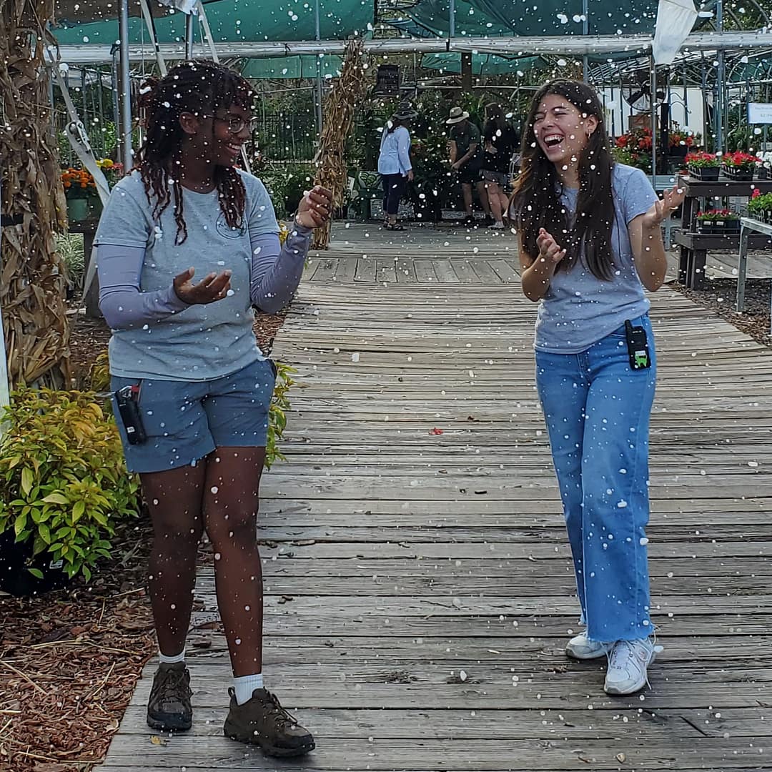 Two Ladies at Kerby's Enjoy the Snow from the Snow Machine