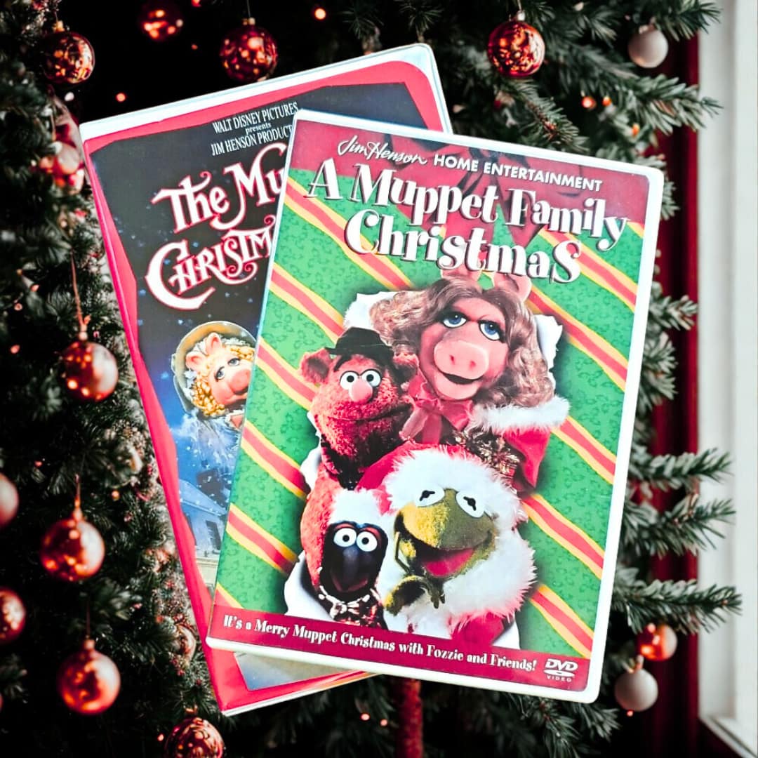 Two Muppet Christmas Movies in DVD Cases in Front of a Christmas Tree