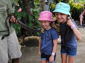 Girls with Boa Constrictor Around Their Necks at a Zoo