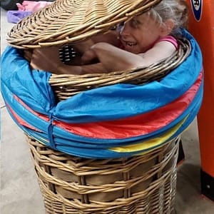 Girl Hiding in a Hamper