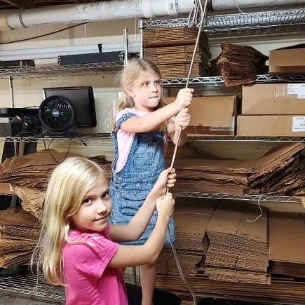 Girls (Abby and Maddy) Helping Pull a Pipe Through a Floor