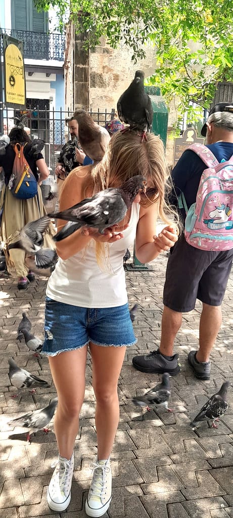Girl with Pigeons on her Head, Shoulder, and Hand