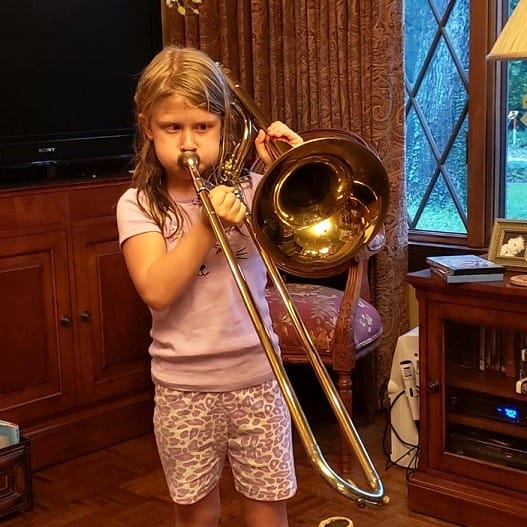 Little Girl (Maddy) Playing a Trombone