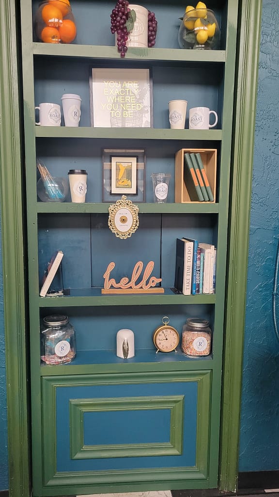 Bookshelf with Cups, Books, and Decor on It