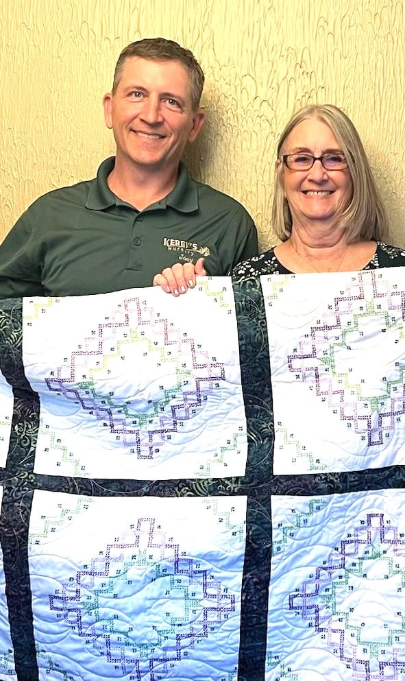 Joey and His Mom Sharon with the Quilt from Her and His Grandmother