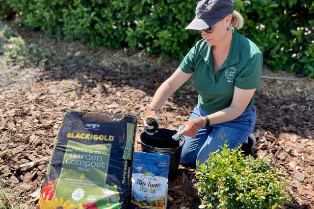 Woman making planting mix.