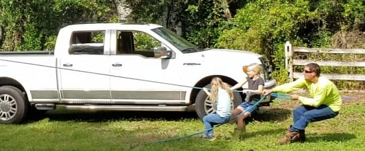 Girls and Man Pulling a Rose to Bring Down a Tree