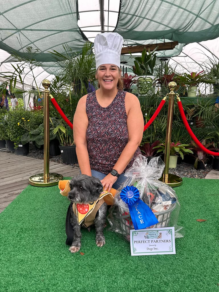 Lady in Chef's Hat with Dog Wearing Pizza Costume