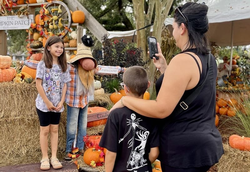 Girl Getting Picture Taken with Gnome Scarecrow