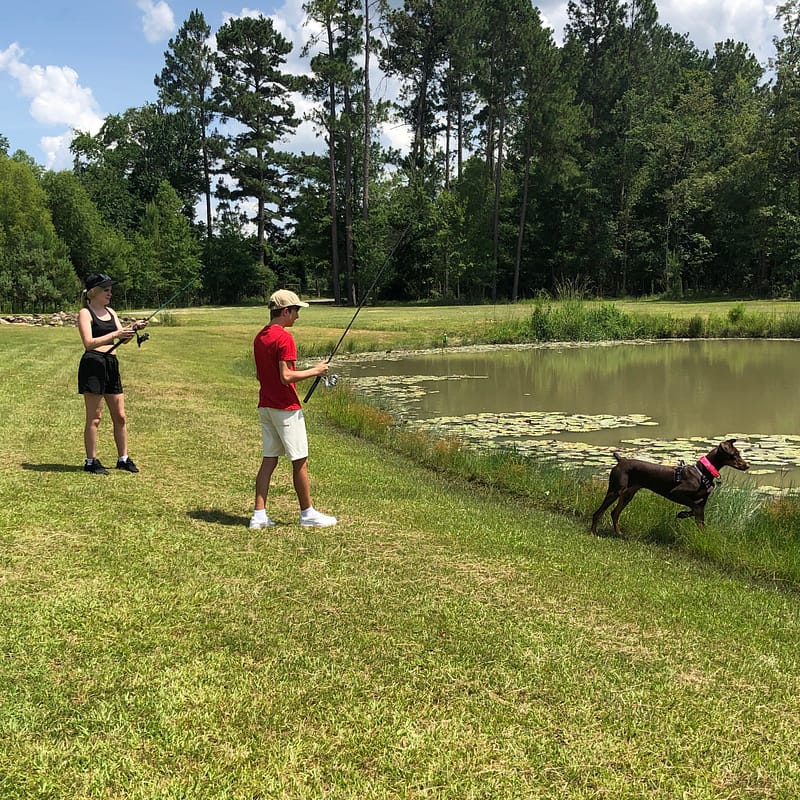 People Fishing with Dog
