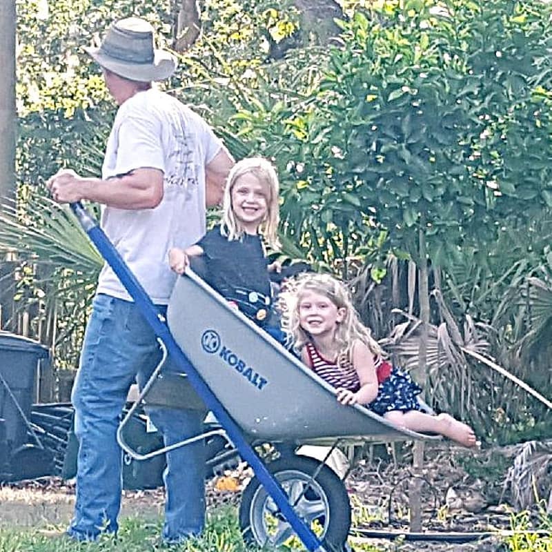 Joey Pulling a Wheelbarrow with Abby and Maddy in It