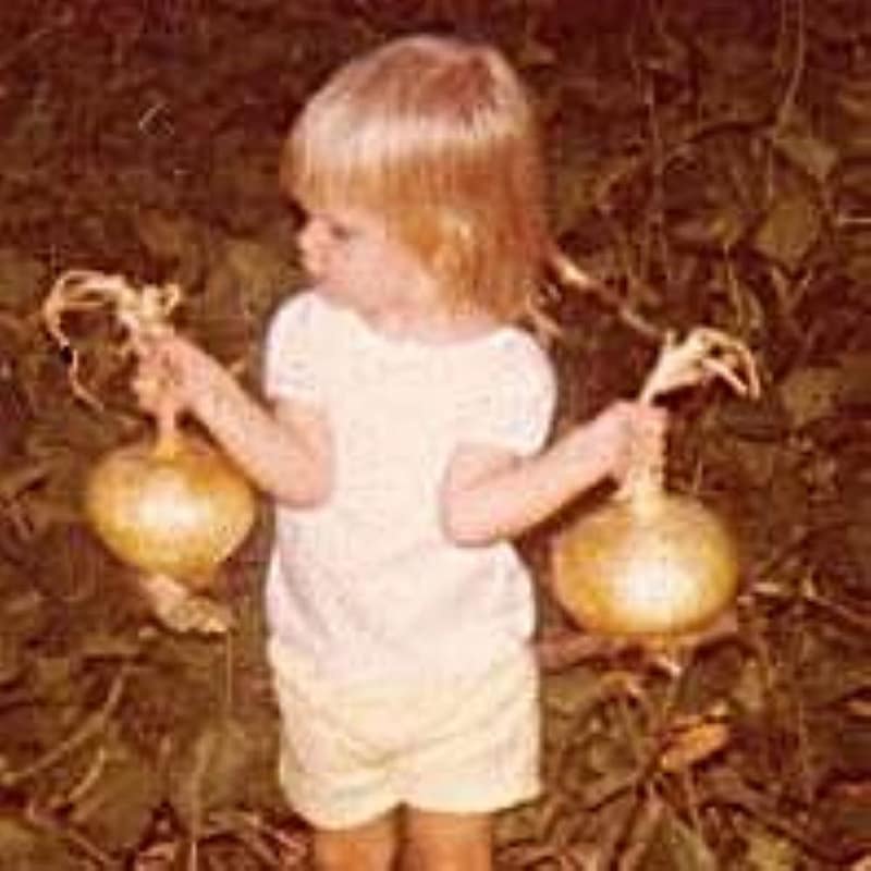 Kim as a Toddler, Holding an Onion in Each Hand