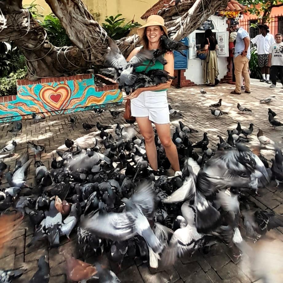 Lady Surrounded by and Holding Pigeons