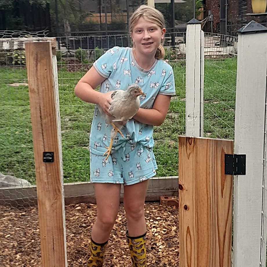 Maddy Holding Her White Chicken Named Henson Boone