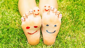 Feet in Grass with Happy Faces