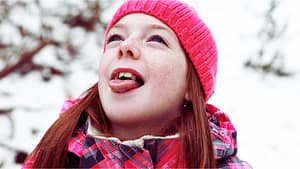 Girl Catching Snowflakes on Tongue