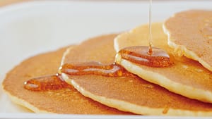 Pancakes with Syrup Being Poured on Them