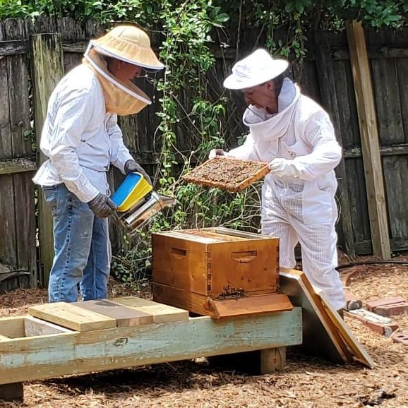 Man and Woman (Joey and Kim) Opening a Beehive