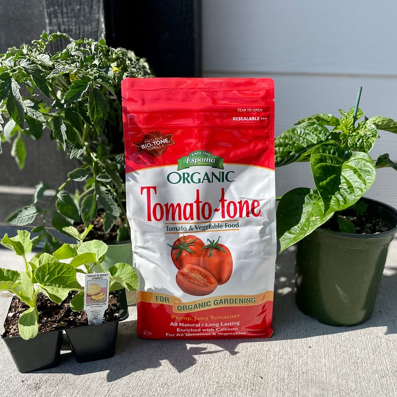 Bag of Espoma Organic® Tomato-tone® Fertilizer with plants