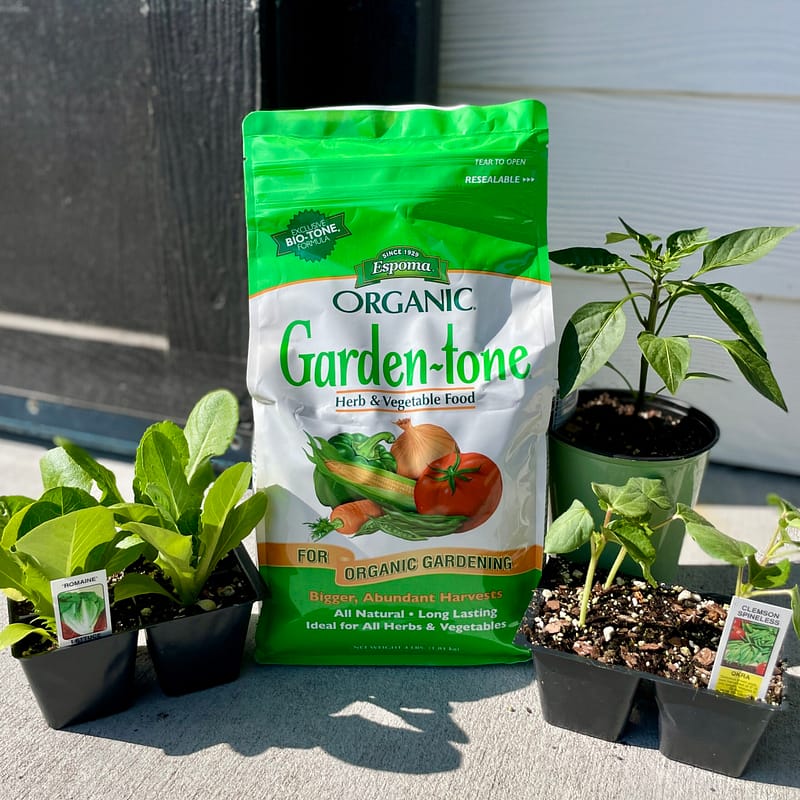 Bag of Espoma Organic® Garden-tone® Fertilizer with plants
